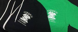 Two shirts with Coucy ARC logo, one black and one green.